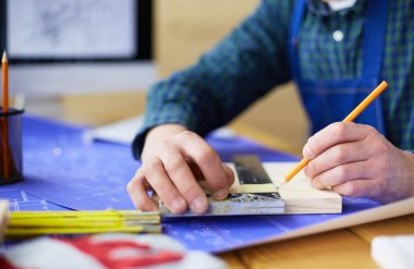 Ofisteki çizim masasında çalışan mimar