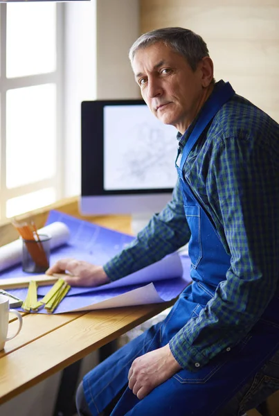 Architect working on drawing table in office