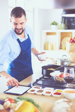 Adam ev mutfağında lezzetli ve sağlıklı yemekler hazırlıyor.