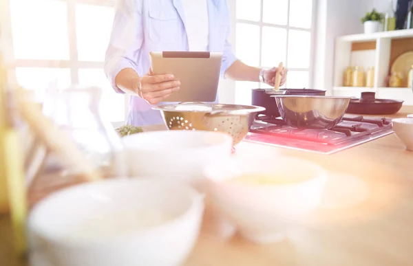 Man following recipe on digital tablet και το μαγείρεμα νόστιμο και υγιεινό φαγητό στην κουζίνα στο σπίτι — Φωτογραφία Αρχείου