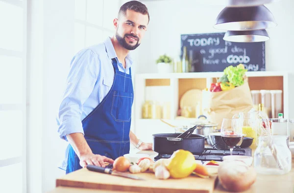 Man preparing delicious and healthy food in the home kitchen