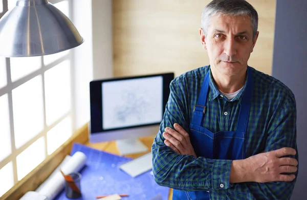 Architect working on drawing table in office