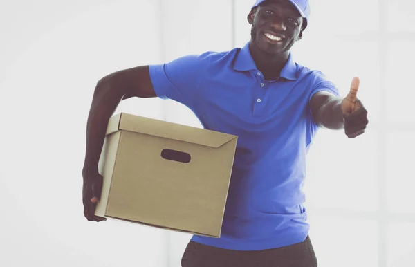 Portrait of an handsome happy deliverer with box — Stock Photo, Image