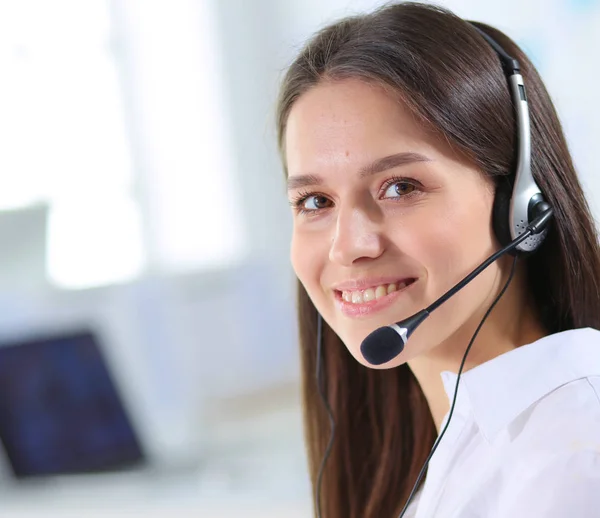 Mujer de negocios sonriente u operador de línea de ayuda con auriculares y computadora en la oficina — Foto de Stock