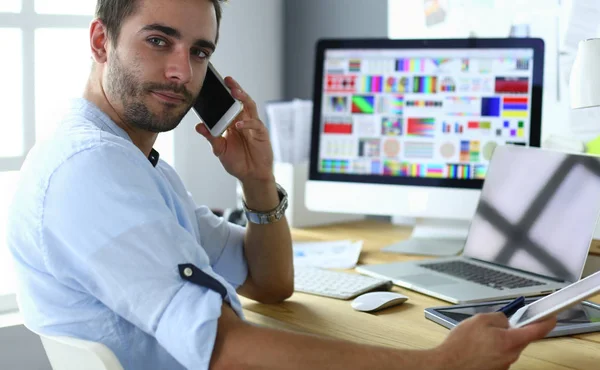 Portrait of young designer sitting at graphic studio in front of laptop and computer while working online. — Stock Photo, Image