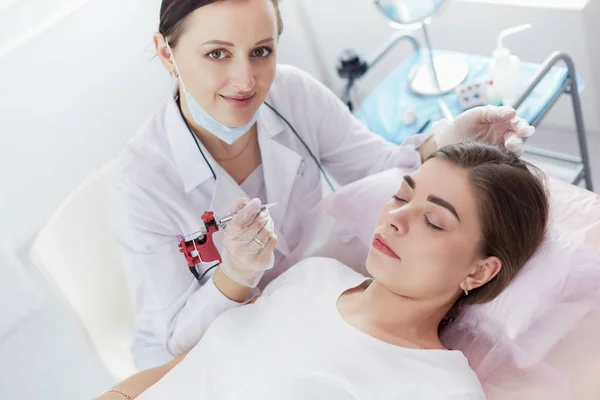 A young girl having red lips permanent makeup, micropigmentation — Stock Photo, Image