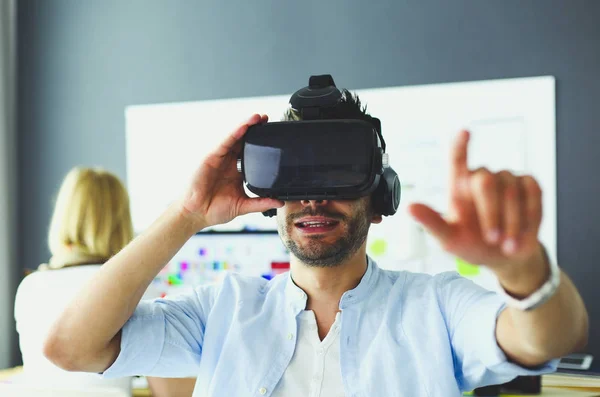 Young male software programmer testing a new app with 3d virtual reality glasses in office. — Stock Photo, Image
