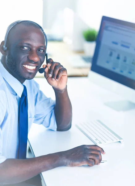 African american businessman on headset working on his laptop — Stock Photo, Image