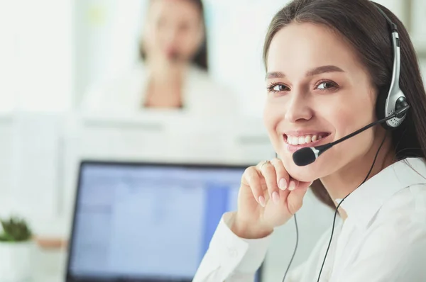 Smiling businesswoman or helpline operator with headset and computer at office — Stock Photo, Image