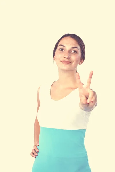 Retrato de una joven sonriente señalando hacia arriba — Foto de Stock