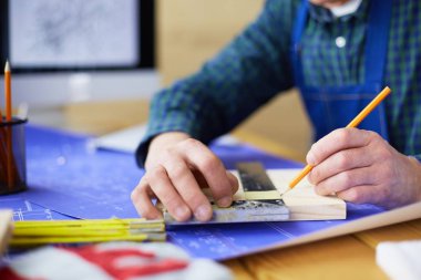 Ofisteki çizim masasında çalışan mimar