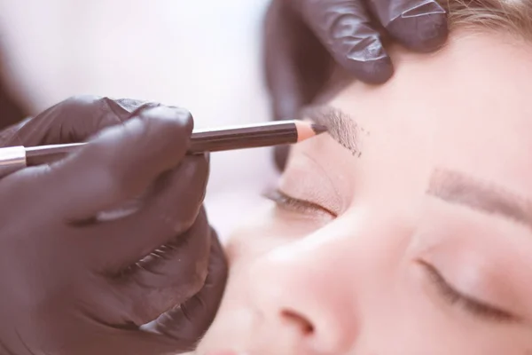 美容师在眉毛上涂永久化妆品 — 图库照片