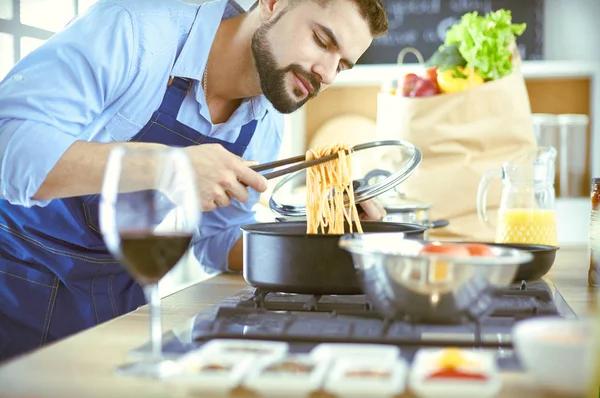 Man preparing delicious and healthy food in the home kitchen