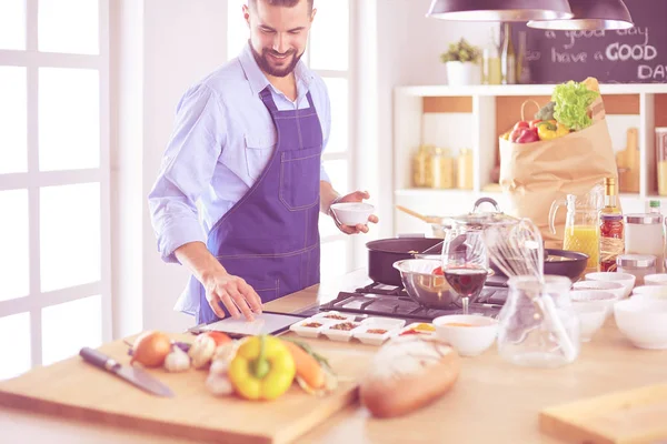 Uomo che prepara cibo delizioso e sano nella cucina di casa — Foto Stock