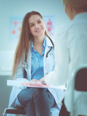 Doktor ve hasta masada otururken bir şey tartışıyorlar. İlaç ve sağlık hizmetleri kavramı