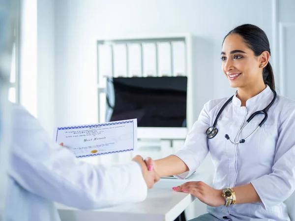 Doctor schudt handen met een patiënt geïsoleerd op witte achtergrond — Stockfoto