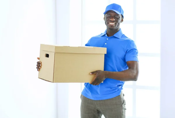 Portrait of an handsome happy deliverer with box — Stock Photo, Image