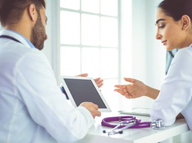 Tıbbi ekip masada oturup tartışıyor.