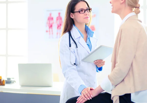 Docteur et patient discutant de quelque chose assis à la table. Médecine et soins de santé concept — Photo