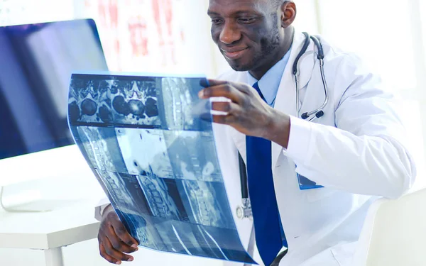 Portrait young african medical doctor holding patients x-ray — Stock Photo, Image