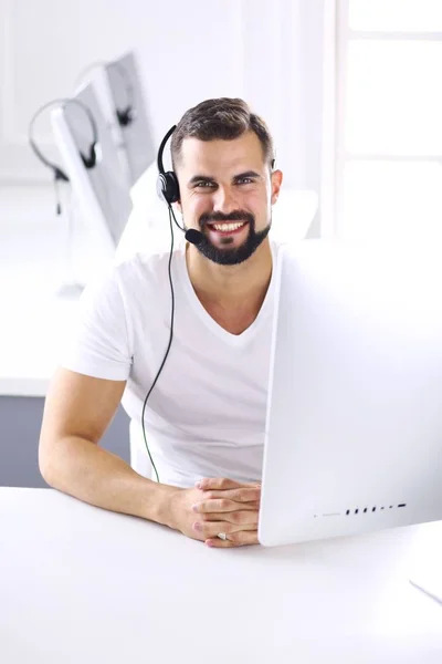 Empresario en la oficina en el teléfono con auriculares, Skype — Foto de Stock