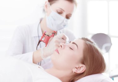 Kırmızı dudaklı genç bir kız kalıcı makyaj, mikro pigmentasyon