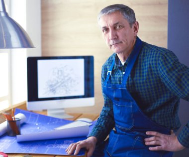 Ofisteki çizim masasında çalışan mimar