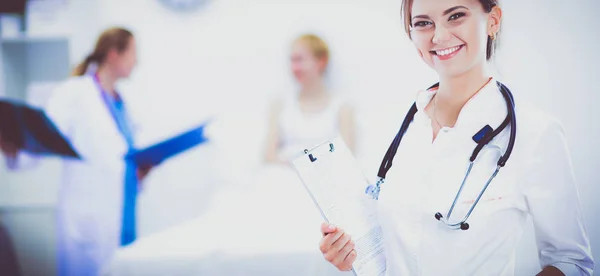 Young woman doctor standing at hospital with medical stethoscope — Stock Photo, Image