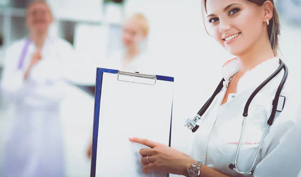 Young woman doctor standing at hospital with medical stethoscope