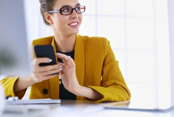 Empresaria sentada en oficina con laptop por teléfono — Foto de Stock