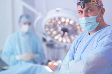 Male surgeon on background in operation room clipart
