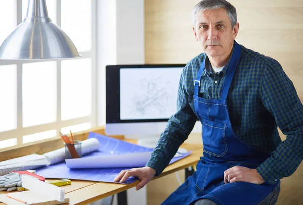 Architect working on drawing table in office
