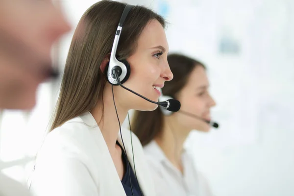 Smiling businesswoman or helpline operator with headset and computer at office — Stock Photo, Image