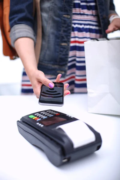 Customer is paying with smartphone in shop using NFC technology. NFC technology. Customer is paying — Stock Photo, Image