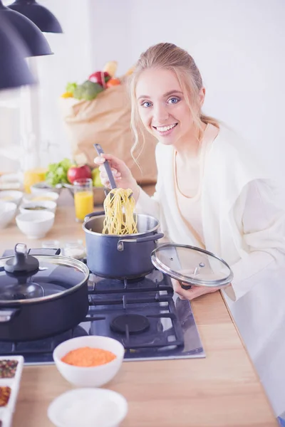 Beautiful young woman cooking in kitchen at home — Stock Photo, Image