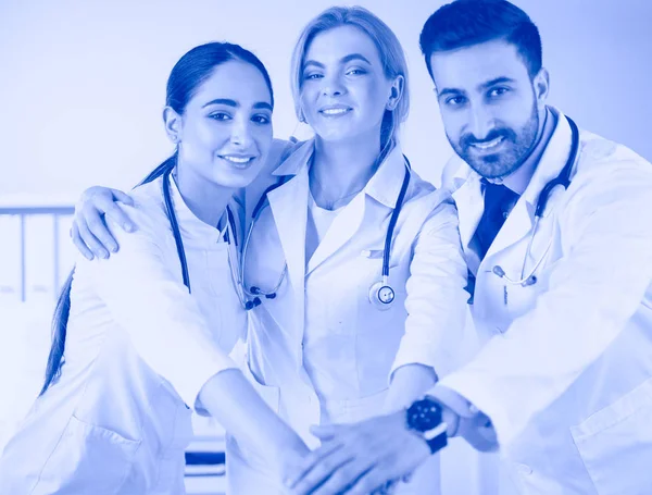 Successful medical team. Confident doctors team standing together and smiling