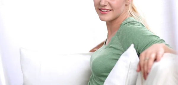 Young beautiful woman sitting on couch at her room — Stock Photo, Image