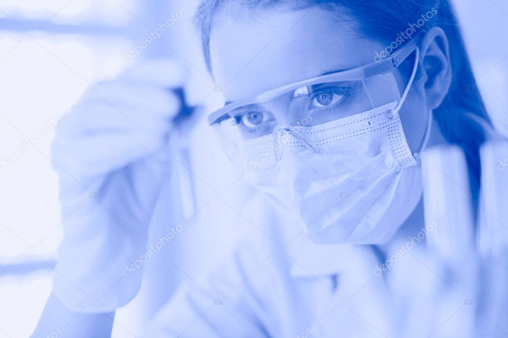 Researcher, doctor, scientist or laboratory assistant working with plastic medical tubes in modern lab or hospital