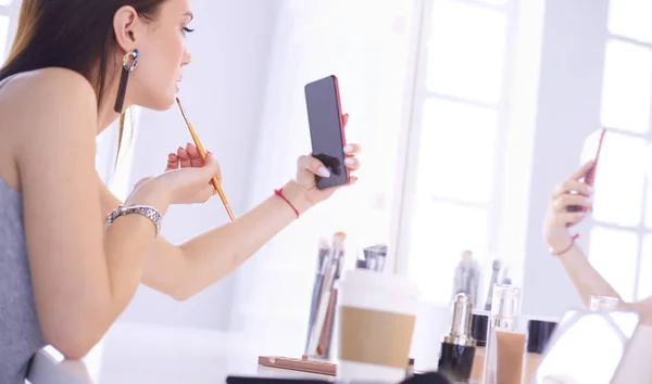 Female young beautiful girl with curly hair and make-up. beautiful woman make self-portrait yourself by phone — Stock Photo, Image