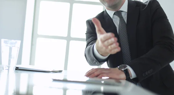 Porträt eines jungen Mannes, der an seinem Schreibtisch im Büro sitzt. — Stockfoto