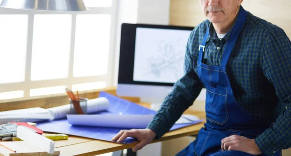 Architect working on drawing table in office — Stock Photo, Image