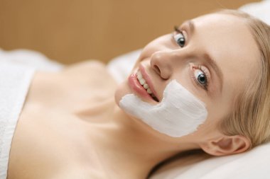 Spa facial mask application. Spa beauty organic facial mask application at day spa salon. clipart