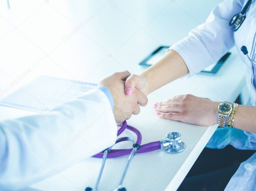 Young medical people handshaking at office