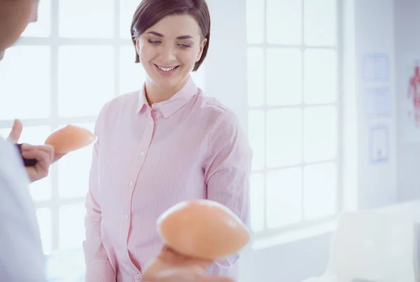 Doctor showing young patient her chest in his office at the hospital — Stock Photo, Image