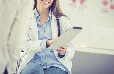 Doktor ve hasta masada otururken bir şey tartışıyorlar. İlaç ve sağlık hizmetleri kavramı