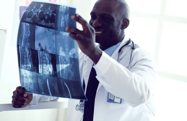 Portrait young african medical doctor holding patients x-ray — Stock Photo, Image