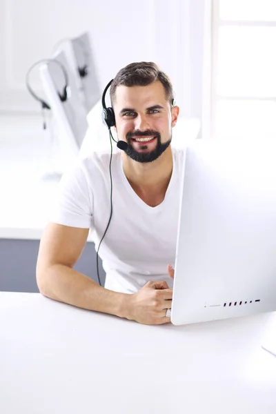 Businessman in the office on the phone with headset, Skype — Stock Photo, Image