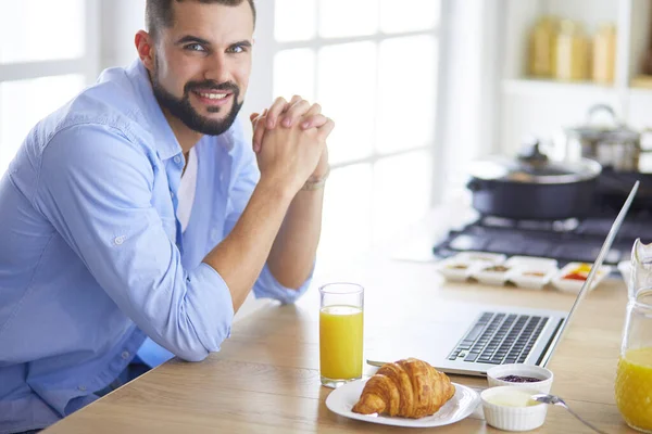 Man preparing delicious and healthy food in the home kitchen