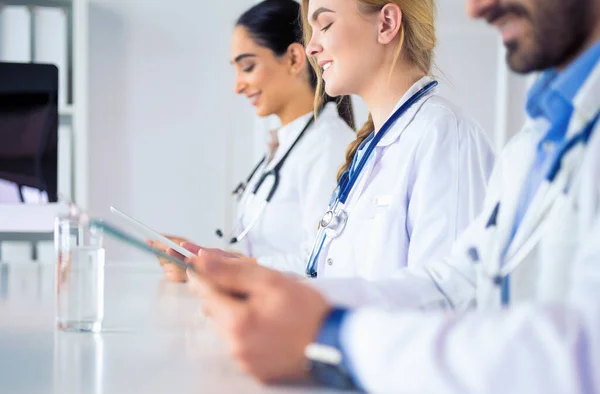 Médecins à la réunion, assis sur le bureau — Photo