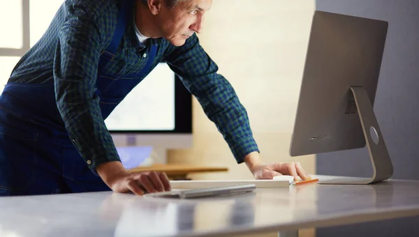 Architect working on drawing table in office — Stock Photo, Image